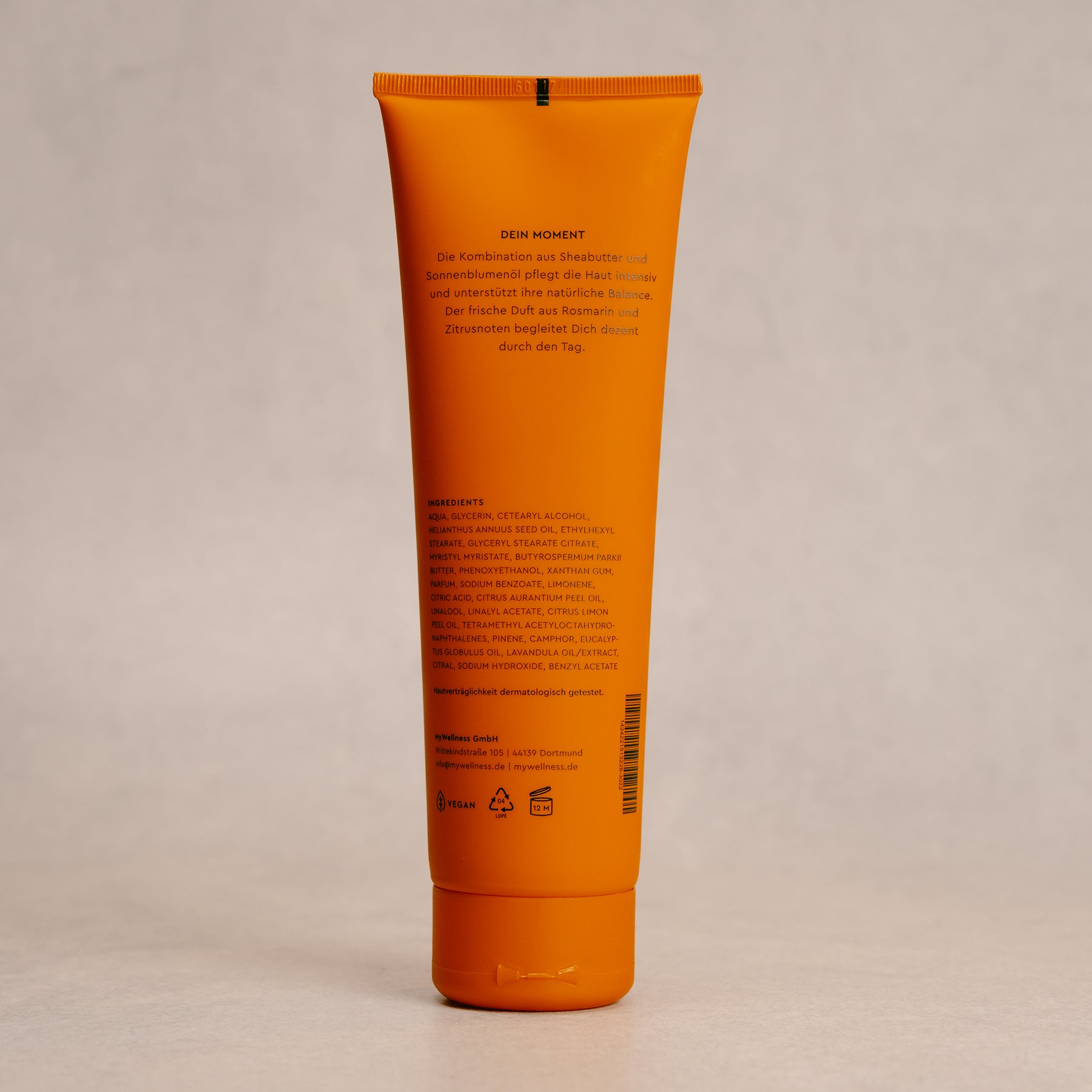 Nahaufnahme der Rückseite MyWellness Bodylotion Orange Tube mit Inhaltsstoffen vor neutralem Hintergrund
